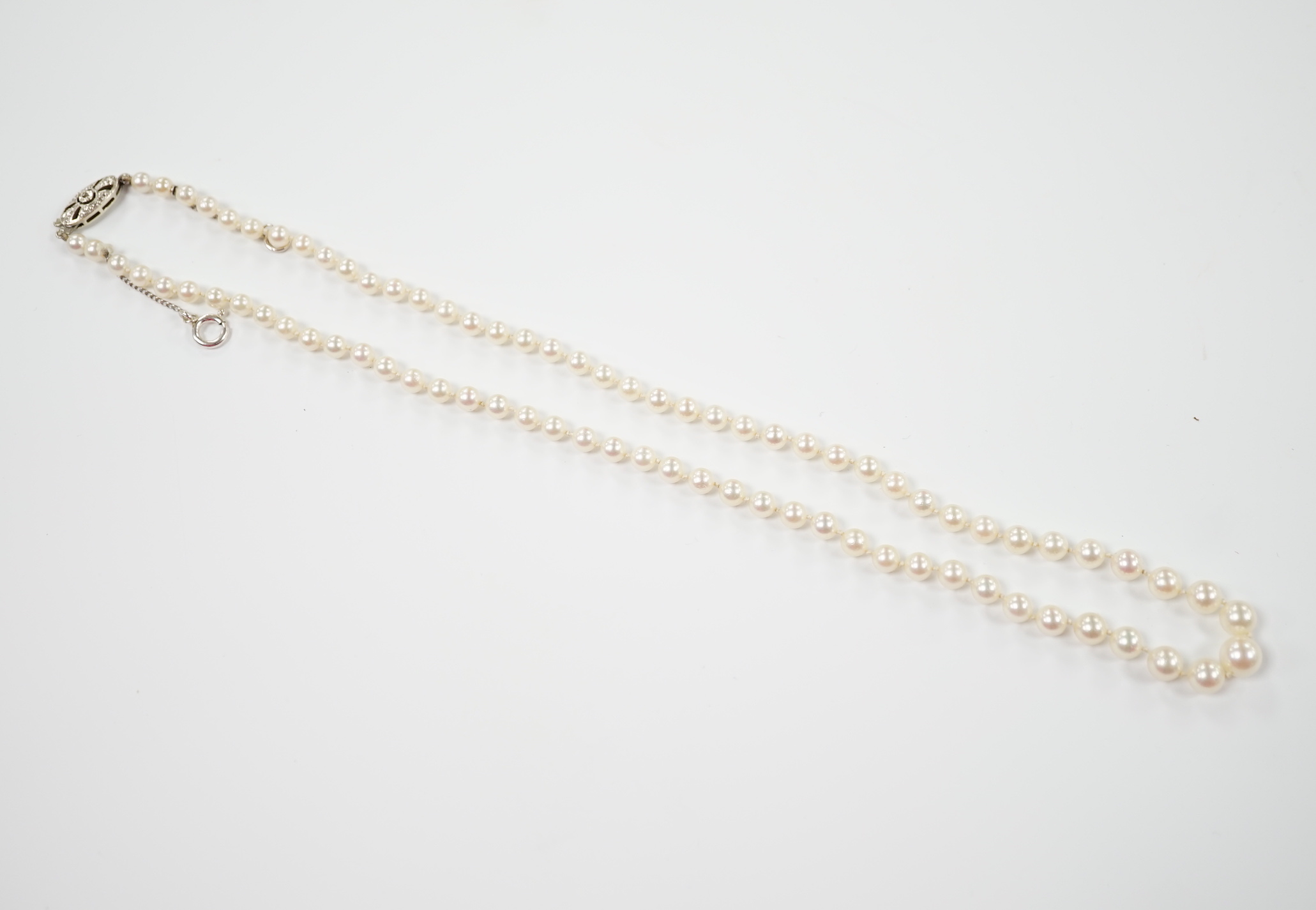 A single strand graduated cultured pearl necklace, with single stone diamond chip set 9ct white metal clasp, 46cm.